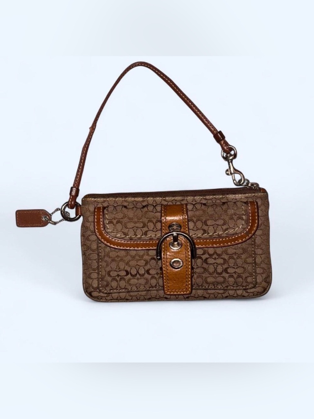 Brown Coach wristlet with detachable strap.